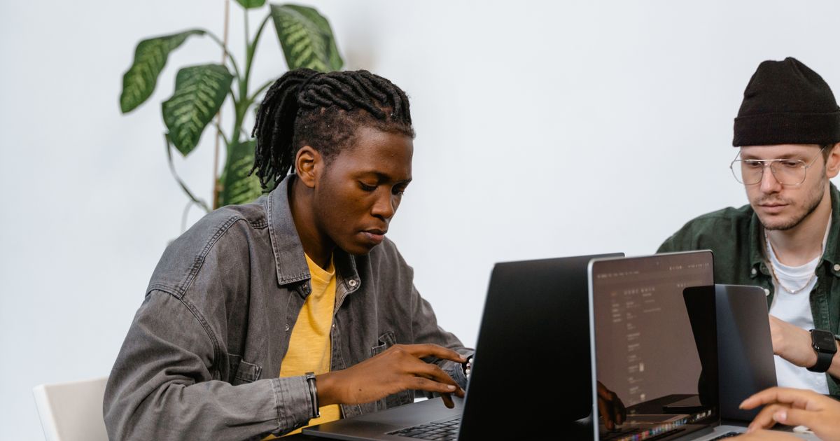 A startup team working together on laptops